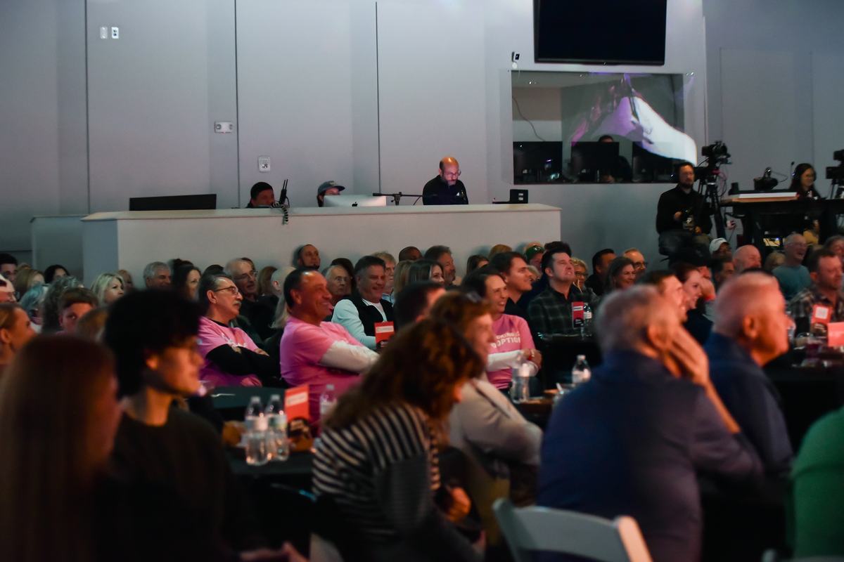 Audience laughing at their tables